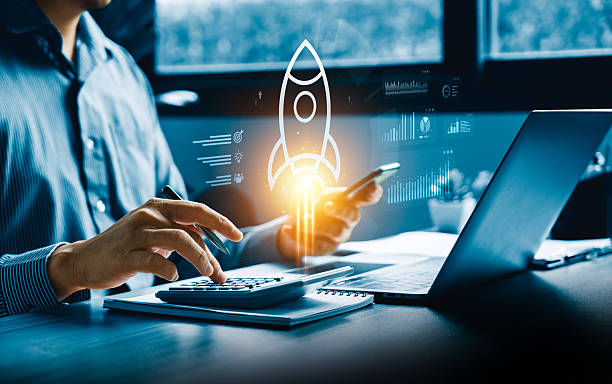 Business professional calculating budgets with a digital rocket icon symbolizing startup growth, financial planning, innovation, strategic development supported by modern technology, data analytics