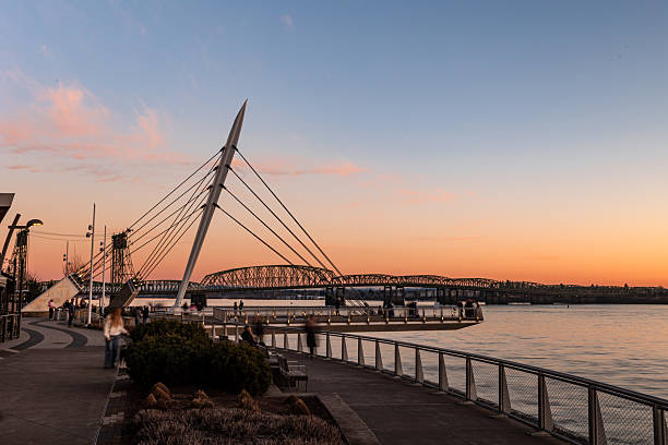 The Vancouver Washington Waterfront Park At Twilight, shot with a ND filter to slow the shutter speed and blur the people visiting the park. This is a popular location to visit in Vancouver, Washington, and the pier overlooks the Columbia River.