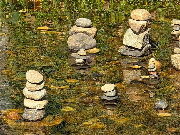 Rock balancing or Rock cairns in a river