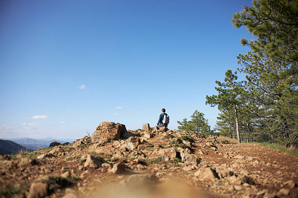 Young man hiking mountain.