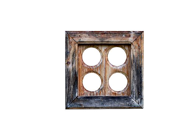 Old wooden window frame on a log house wall. Traditional rural architecture, natural wood texture, rustic and ethnic style background for design concepts.