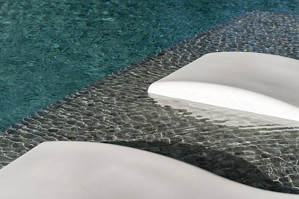 Crystal clear water rippling at the edge of a modern pool.