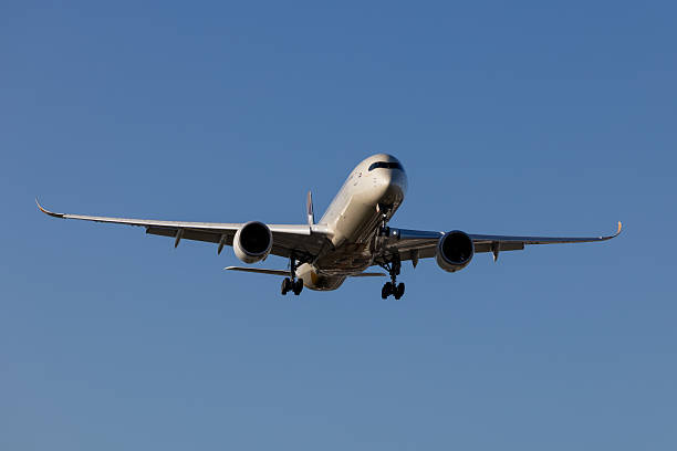 An Etihad Airways Airbus A350-1041 plane, registration A6-XWE, landing at Sydney Kingsford Smith Airport as flight EY454 from Abu Dhabi. This image was taken from near Nigel Love Bridge, Mascot on a hot and sunny afternoon on 23 January 2026.