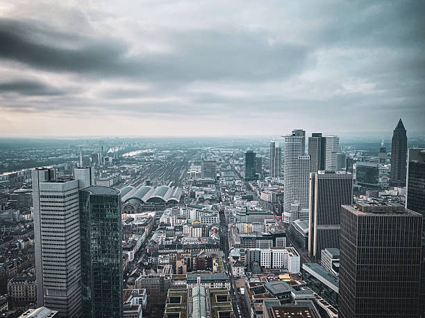 The skyline of Frankfurt featuring modern skyscrapers and high-rise buildings, capturing the dynamic urban landscape of Germany’s financial hub. Taken in daylight, emphasizing architectural details and the city’s vibrant atmosphere. Perfect for cityscape, urban photography, architecture, and business themes.
