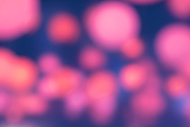 Blurred glowing pink lights bokeh abstract night city party background