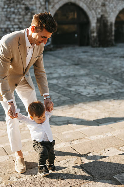 istock Baby boy making first steps in the city 2258084724