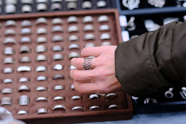 Gold ring in a box in a female hand on a white background isolation
