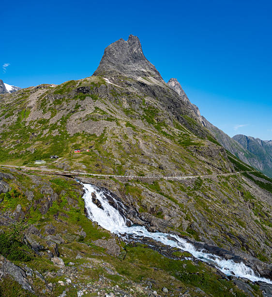 Waterfall and mountain view Trollstigen Norway summer road trip sunny day travel adventure tourism
