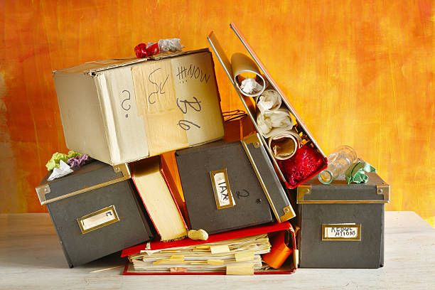 Large stack of files, documents, paperwork on desk
