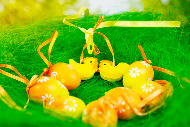 Easter eggs background yellow chicken arrangement green grass decorative composition with floral pattern eggs and hen figures with copy space for banner design holiday, decoration, celebration.