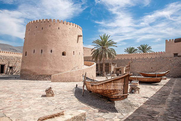 Ancient stone fortress with historical clay stone walls in Khasab Fort Oman with heritage nautical boat and ship artefacts