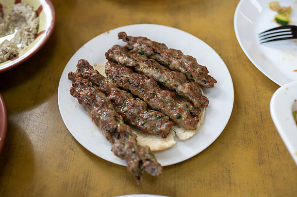 Succulent Lamb Kebabs Served On Flatbread, Bursting With Rich Flavors.