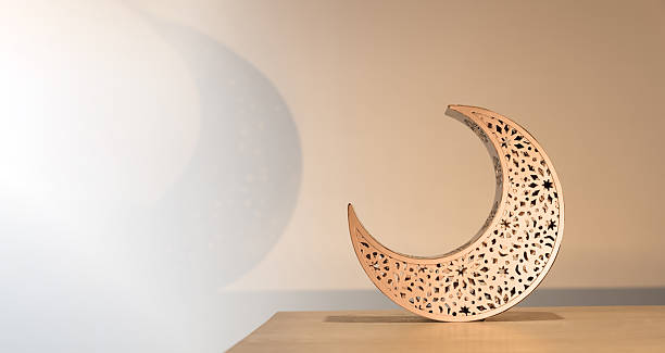 3d golden crescent moon symbol. Yellow metallic moon  with light and shadow for muslim holiday on white isolated background. 3d rendering illustration.