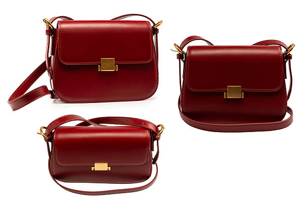 Burgundy shoulder leather bag isolated on a white background.