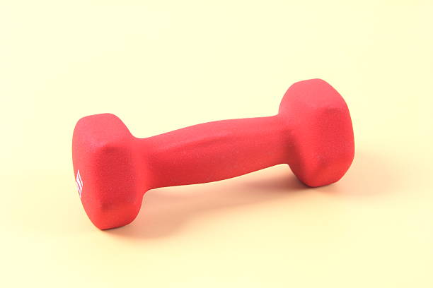 Red dumbbell on yellow background