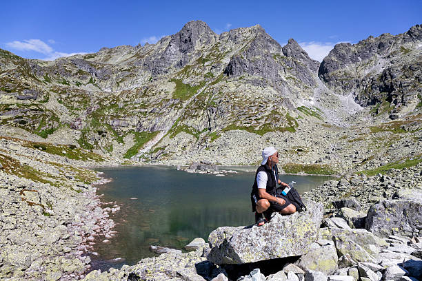 Middle-aged lonely tourist during a trip to the peak of Rysy in the Żabia Mięguszowiecka Valley, Slovakia