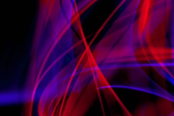 Flowing blue and purple energy lights creating deep abstract luminous motion on dark background.