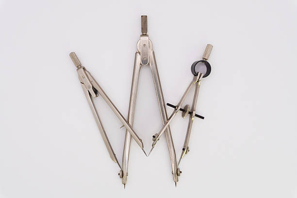 Men's hand holding architect compass on isolated backgroung, close up