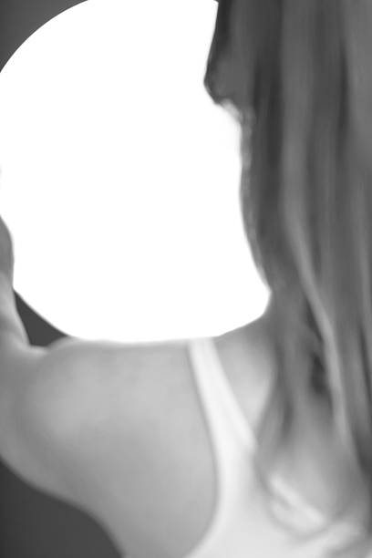 Woman holding a bright, glowing orb, creating a sense of mystery and ethereal light