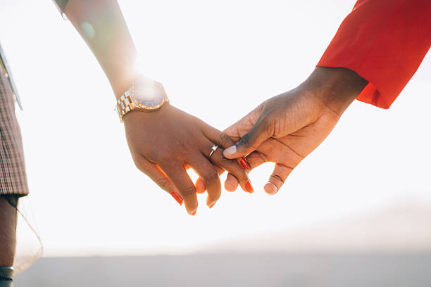 istock Loving couple holding hands showing engagement ring 2258139123