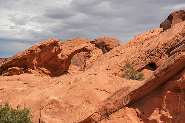 A natural arch seen in Valley of Fire during a hot day in the hot desert landscape in Nevada, USA.