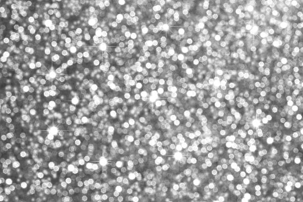 Bright, sparkling silver glitter texture with soft bokeh lights and festive glamour for creative use.