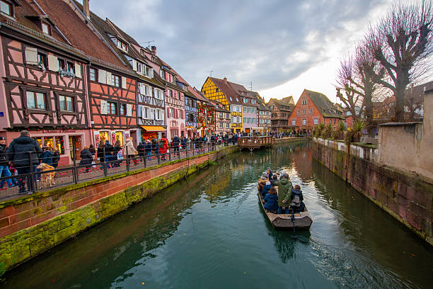Colmar, France - December 7, 2025: Old town of Colmar, Alsace, France. Petite Venice, water canal and traditional half timbered houses. View with colorful buildings.