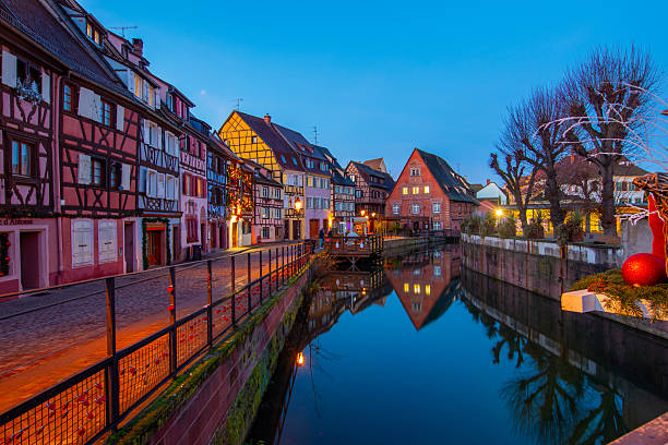 Colmar, France - December 7, 2025: Old town of Colmar, Alsace, France. Petite Venice, water canal and traditional half timbered houses. View with colorful buildings.