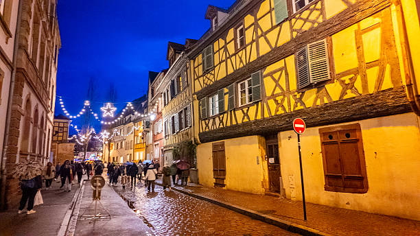 Colmar, France - December 10, 2025: Old town of Colmar, Alsace, France. Petite Venice, water canal and traditional half timbered houses. View with colorful buildings at blue hours.
