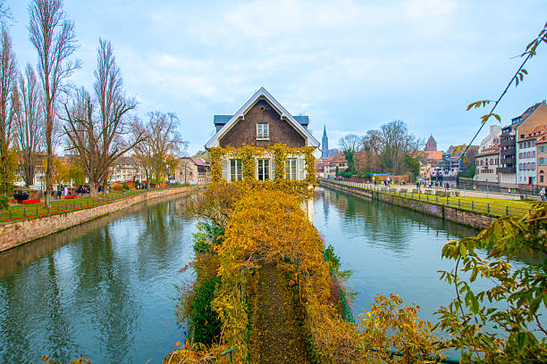 Strasbourg, France - December 5, 2025: Beautiful travel landscape with half-timbered houses on the banks of the river ill and decorated flowers in Strasbourg. France quarter in Strasbourg.