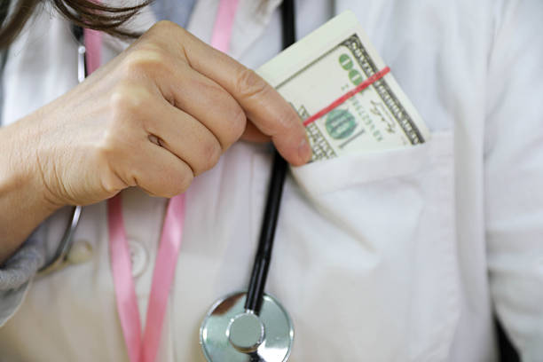 Female Doctor Hiding Cash Money In Medical Coat Pocket While Wearing Stethoscope, Illustrating Healthcare Bribery, Illegal Payments, Ethical Violations, Corruption In Medical System And Abuse Of Professional Trust.