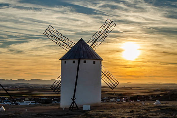 Several windmills at sunset in Campo de Criptana. Colorful sunset with the windmills outdoors. Campo de Criptana, Ciudad Real, Castilla-La Mancha, Spain - September 10, 2017.