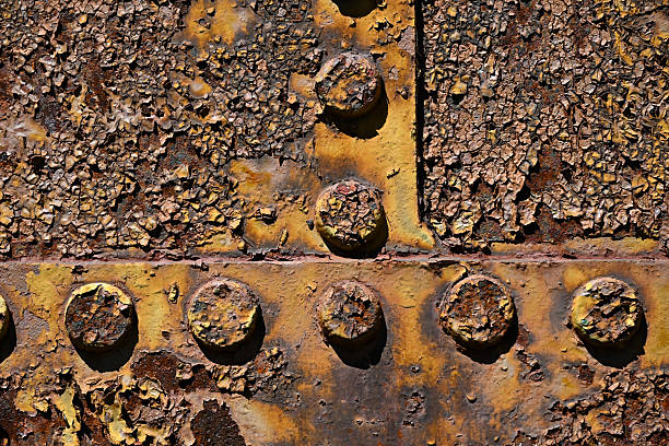 ome very weathered rivets on a storage tank that are undergoing significant corrosion and peeling