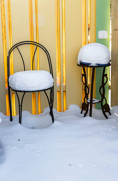 Picnic set in winter on a barnwall, frosty, glistering