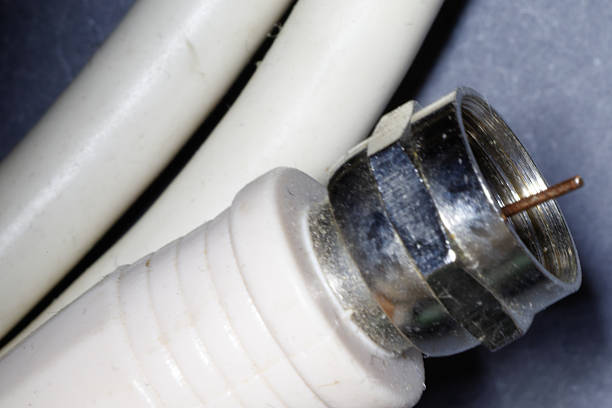 Close-up of tv antenna cable connector, showing metal casing and copper wire