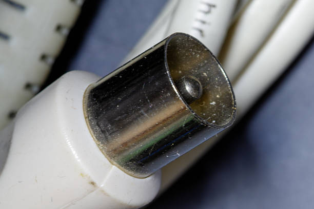 Coaxial plug for tv signal transmission showing metal and plastic components