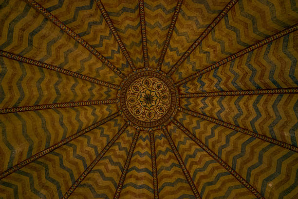 Amber, India - March 16, 2022: The image shows a decorated ceiling at Fort d'Amber featuring radiating geometric zigzag patterns and a central floral medallion.