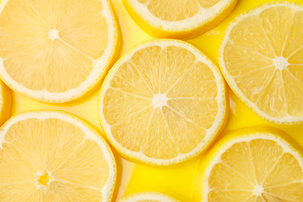 istock Slices of fresh lemon on yellow background, flat lay 2258202650
