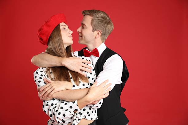 A scared nerdy man being attacked with a kiss from a nerdy woman.
