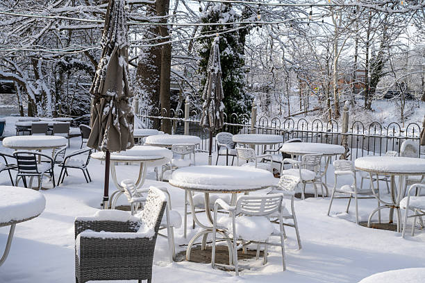 Clinton, USA - January 19, 2026. Outdoor chairs and tables of Riverside Coffee & Tea covered with snow, Clinton, New Jersey, USA