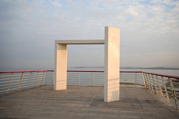Minimalist White Frame Structure on a Seaside Promenade – Abstract Architecture and Sea View