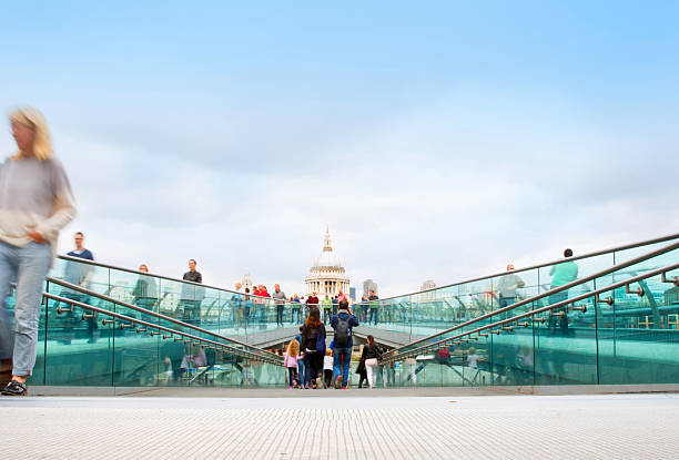 A view along an almost empty London's Millennium Bridge towards St Paul's Cathedral. Composite image.