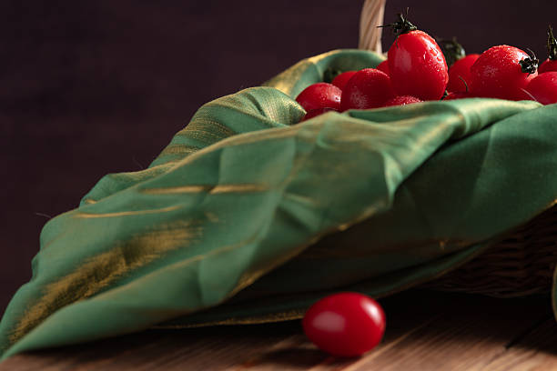 cherry tomatoes on green satin