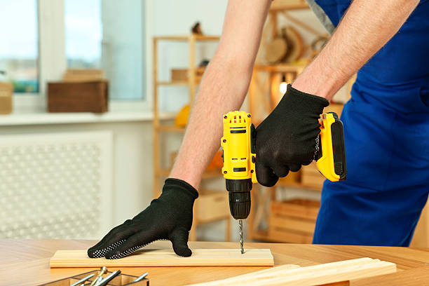 istock Craftsman working with drill at wooden table in workshop, closeup 2258216737