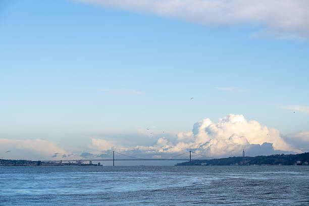 Lisbon symbol - Jesus statue, 25 da Avril bridge and Cais das Colunas. Lisbon, Portugal