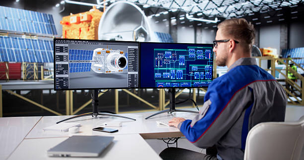 Young Caucasian Male Engineer Designing Satellite With Solar Panels On Computer.