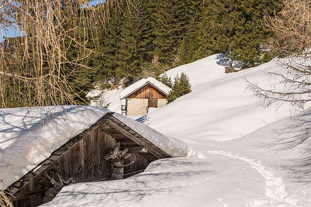 Wooden house in a beautiful winter landscape, Dolomite Alps. Val Di Fassa, Italy