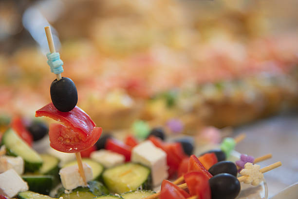 Appetizer skewers with olives, cheese, tomato, and cucumber