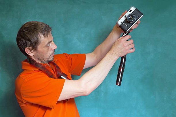 Male photographer with analog camera and film.