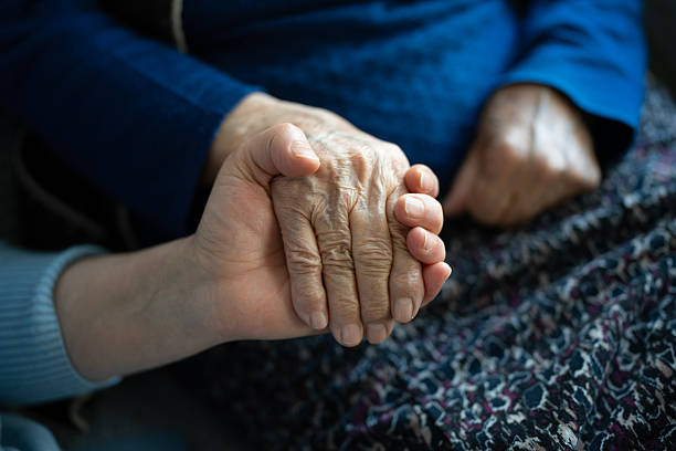 istock Young hand holding senior woman's wrinkled hand 2258279872